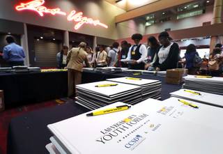 Students pick up pens and notebooks in the lobby of the Las Vegas Convention Center before the 61st annual Las Vegas Sun Youth Forum Wednesday, Nov. 8, 2017.