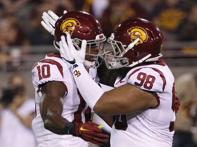 Southern California linebacker John Houston Jr. (10) is congratulated by teammate Josh Fatu after blocking a pass during the first half of an NCAA college football game against Arizona State, Saturday, Oct. 28, 2017, in Tempe, Ariz. Southern California defeated Arizona State 48-17. 