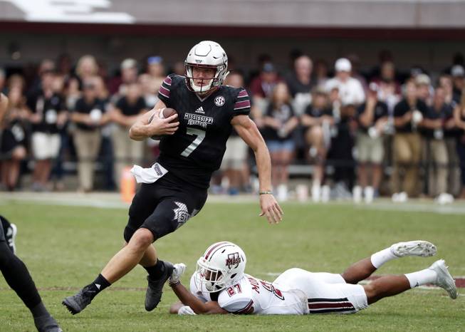 Mississippi State quarterback Nick Fitzgerald (7) runs past Massachusetts defenders in the second half of an NCAA college football game in Starkville, Miss., Saturday, Nov. 4, 2017. No. 21 Mississippi State won 34-23. (AP Photo/Rogelio V. Solis)