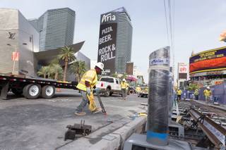Construction workers install bollards along the Strip sidewalk in front of Paris Hotel and Casino, Monday, Nov. 13, 2017. In an effort to keep pedestrians safe, the city of Las Vegas plans to install 800 bollards by New Year's Eve.