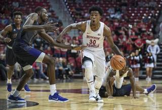 UNLV's guard Jovan Mooring (30) powers down the lane past Prairie View A&M's forward Keion Alexander (1) and teammates during their game at the Thomas & Mack Center on Wednesday, Nov. 15, 2017.