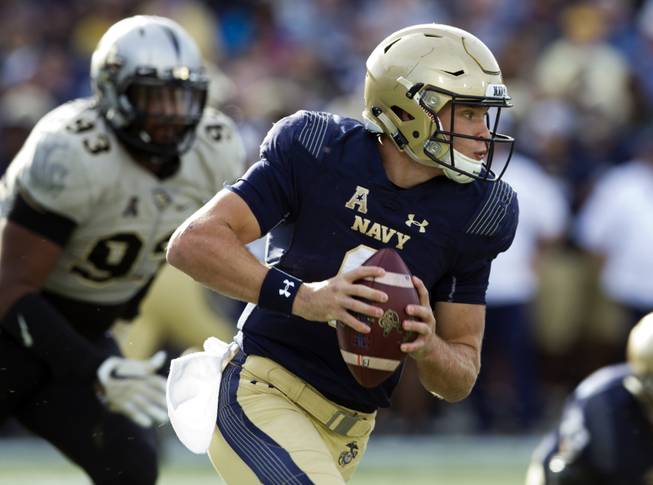 Navy quarterback Zach Abey (9) runs with the ball during the first half of an NCAA college football game against Central Florida in Annapolis, Md., Saturday, Oct. 21, 2017. 