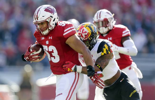 FILE - In this Saturday, Oct. 21, 2017, file photo, Wisconsin linebacker T.J. Edwards returns an interception for a touchdown against Maryland wide receiver Jahrvis Davenport during the first half of an NCAA college football game in Madison, Wis. Such a picky defense at No. 5 Wisconsin. Not only do the Badgers excel at getting interceptions, but they're a threat to score on defense too, tied with Duke for an FBS-leading four pick-6s this season. 