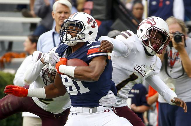 Auburn wide receiver Darius Slayton (81) is tackled by Louisiana Monroe safety Roland Jenkins (2) and cornerback Juwan Offray (1) after a reception in the first half of an NCAA college football game, Saturday, Nov. 18, 2017, in Auburn, Ala. (AP Photo/Butch Dill)