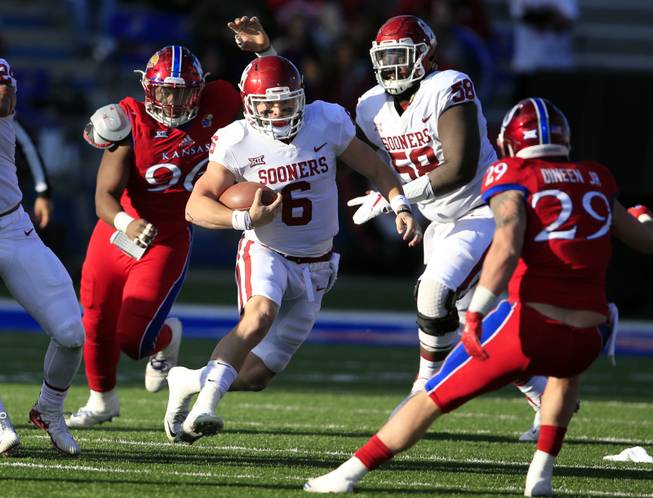 Oklahoma quarterback Baker Mayfield (6) during the first half of an NCAA college football game against Kansas in Lawrence, Kan., Saturday, Nov. 18, 2017. (AP Photo/Orlin Wagner)