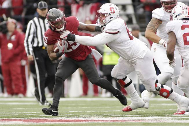 Stanford defensive tackle Harrison Phillips, right, tackles Washington State running back Jamal Morrow (25) during the second half of an NCAA college football game in Pullman, Wash., Saturday, Nov. 4, 2017. 