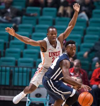 UNLV's guard Jordan Johnson (24) defends the lane well and Oral Roberts' guard R.J. Fuqua (24) is turned back on a drive during their game at the MGM Grand Garden Arena on Tuesday, Dec.. 5, 2017.