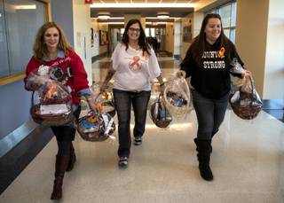 Desert Springs Hospital COO Andrea Davis joins members of a group organized by Denver-organized Route 91 shooting survivors including Angel Cortum and Angelic Parrinello to deliver some of about 1000 thank-you baskets to first responders there and at many other Las Vegas locations on Friday, Dec. 8, 2017.