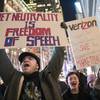 In this Thursday, Dec. 7, 2017, file photo, demonstrators rally in support of net neutrality outside a Verizon store in New York.