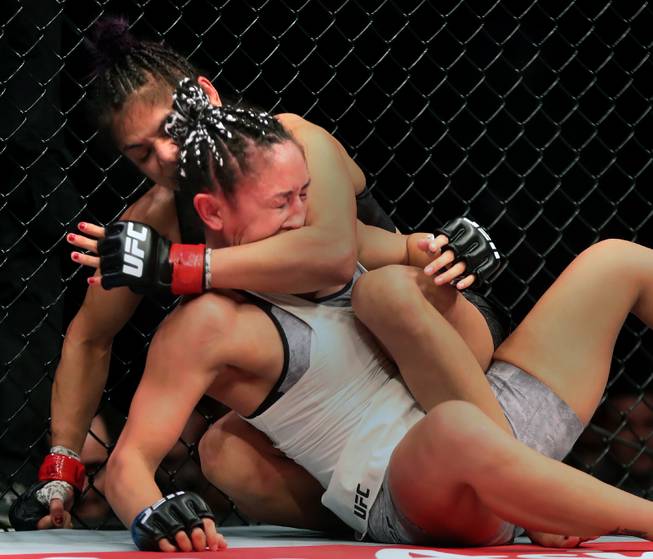 Womens Strawweight Cynthia Calvillo gets a cross face from behind on Carla Esparza during their UFC219 fight at the T-Mobile Arena on Saturday, Dec. 30, 2017.