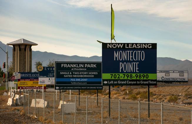Signs for numerous housing construction projects about in Skye Canyon in the Las Vegas area on Wednesday, Jan. 3, 2018.