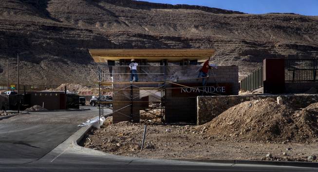 Workers continue to work on the entry way for the new Nova Ridge housing development in western Las Vegas on Wednesday, Jan. 3, 2018.