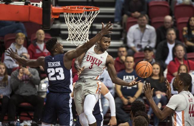 UNLV Rebels guard Amauri Hardy (3) dishes off a pass to teammate UNLV Rebels forward Brandon McCoy (44) with Utah State Aggies forward Daron Henson (23) defending close during their game at the Thomas & Mack Center on Saturday, Jan. 6, 2018.