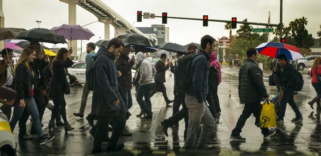 CES attendees make their way through the rains the show takes over the Las Vegas Convention Center on Tuesday, Jan. 9, 2018.