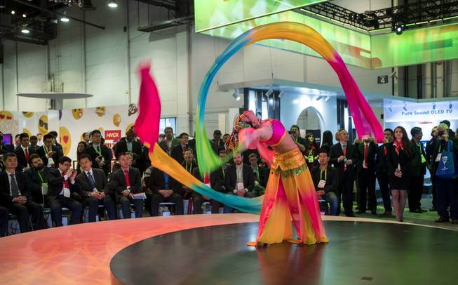 A rhythm ribbon dancer entertains those attending a Changhong demonstration as CES takes over the Las Vegas Convention Center on Tuesday, Jan. 9, 2018.