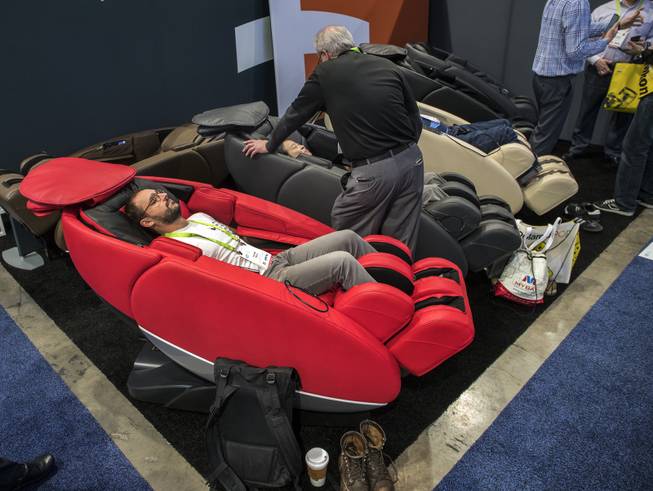 Attendees enjoy a massage and extreme comfort within a chair by Human Touch as CES takes over the Las Vegas Convention Center on Tuesday, Jan. 9, 2018.