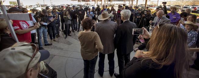 Attorney Larry Layman stands by client Cliven Bundy and his wife Carol as he holds a press conference in front of Metro Police Headquarters on Wednesday, Jan. 10, 2018.