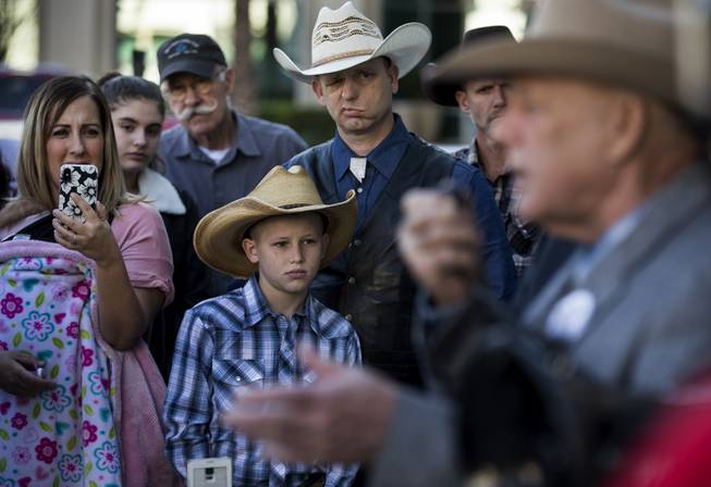 Ryan Bundy and son Oak join others as his father Cliven Bundy holds a press conference in front of Metro Police Headquarters on Wednesday, Jan. 10, 2018.