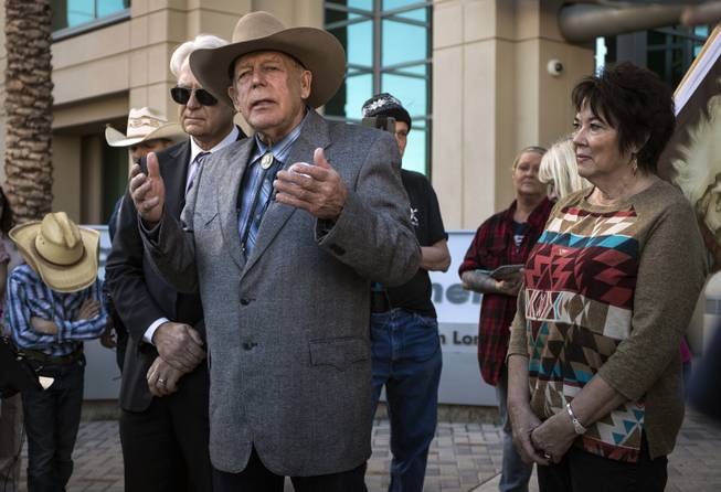 Attorney Larry Layman stands by client Cliven Bundy and his wife Carol as he holds a press conference in front of Metro Police Headquarters on Wednesday, Jan. 10, 2018.
