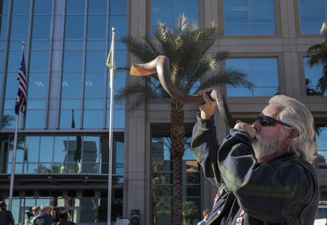 Brand Thornton blows a Kudu horn as Cliven Bundy readies to hold a press conference in front of Metro Police Headquarters on Wednesday, Jan. 10, 2018.