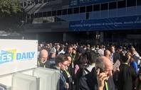 Some of the thousands of CES attendees wait outside the Las Vegas Convention Center or head to one of the gadget show's other sites after a power outage Wednesday, Jan. 9, 2018.