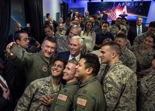 Vice President Mike Pence stands with members of the military for a photo while joining Secretary of the Air Force Heather Wilson and Senator Dean Heller to deliver remarks at the grand opening of AFWERX Vegas on Thursday, Jan. 11, 2018.