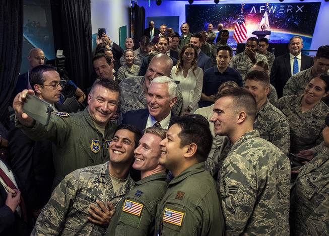 Vice President Mike Pence stands with members of the military for a photo while joining Secretary of the Air Force Heather Wilson and Senator Dean Heller to deliver remarks at the grand opening of AFWERX Vegas on Thursday, Jan. 11, 2018.
