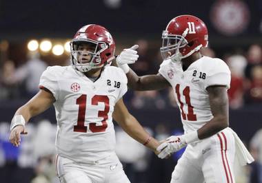 Alabama quarterback Tua Tagovailoa congratulates Henry Ruggs III (11) after his touchdown catch during the second half of the NCAA college football playoff championship game against Georgia, Monday, Jan. 8, 2018, in Atlanta.