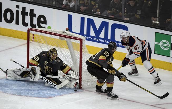 Vegas Golden Knights goaltender Marc-Andre Fleury (29) protects the net with help from Vegas Golden Knights defenseman Shea Theodore (27) versus Edmonton Oilers center Connor McDavid (97) during their game at the T-Mobile Arena.