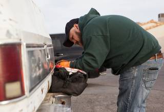 Volunteer Nicholas Marquart works on Kim Berlynn's truck during a free brake light repair clinic hosted by the Las Vegas Democratic Socialists of America at the First African Methodist Episcopal Church in North Las Vegas, Nev., on Saturday, Jan. 6, 2018.