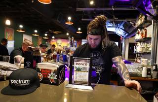 Bartender Victor Mathis rings up a drink order during a cocktail get-together with members of the marijuana industry at Cheba Hut, a marijuana-themed sandwich shop and bar, at Sahara Avenue and Rainbow Boulevard, Thursday, Jan. 18, 2018.