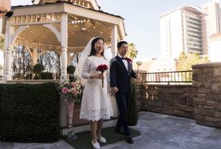 Randy Wang, right, and Ha Na, left, both from Beijing China, get married on Valentine's Day at Vegas Weddings on, Wednesday, February 14, 2018.
