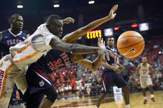 UNLV Rebels forward Cheikh Mbacke Diong (34) and Fresno State Bulldogs guard Deshon Taylor (21) chase after a loose ball during a game at the Thomas & Mack Center Wednesday, Feb. 21, 2018.