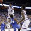Kansas' Malik Newman (14) is fouled on his way to the basket by Duke's Wendell Carter Jr (34) during overtime of a regional final game in the NCAA men's college basketball tournament Sunday, March 25, 2018, in Omaha, Neb. 