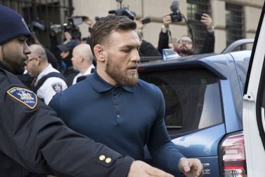 Ultimate fighting star Conor McGregor heads to a vehicle to leave Brooklyn Criminal Court, Friday, April 6, 2018 in New York.
