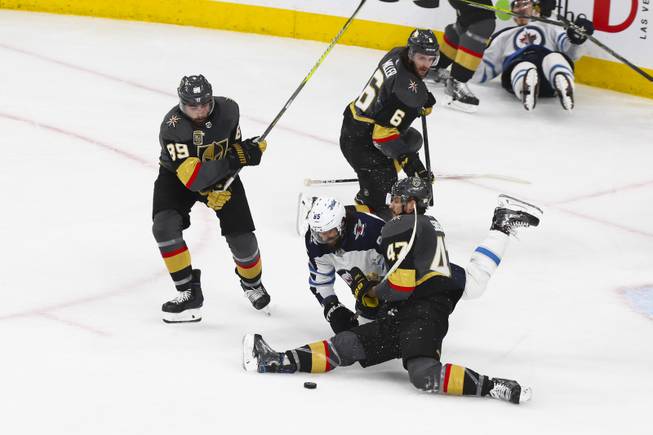 Vegas Golden Knights defenseman Luca Sbisa (47) and Winnipeg Jets center Mathieu Perreault (85) trip over each other during Game 3 in an NHL Western Conference Finals at T-Mobile Arena, Wednesday, May 16, 2018. WADE VANDERVORT