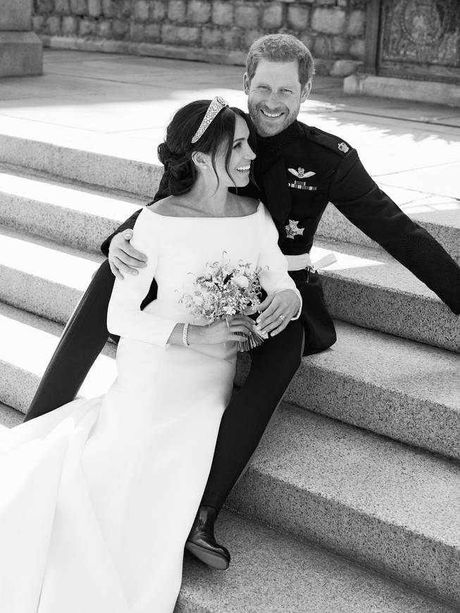 This photo released by Kensington Palace on Monday May 21, 2018, shows an official wedding photo of Britain's Prince Harry and Meghan Markle, on the East Terrace of Windsor Castle, Windsor, England, Saturday May 19, 2018.