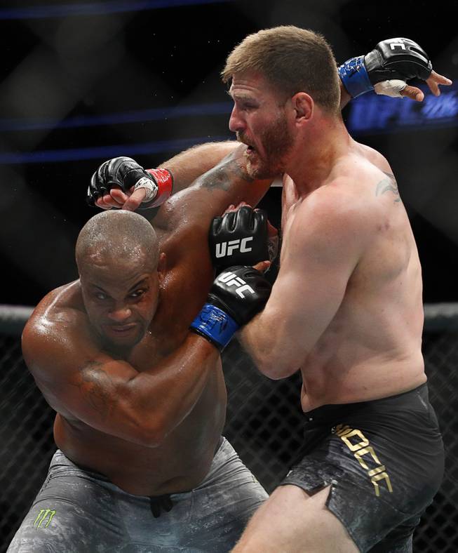 Daniel Cormier, left, fights Stipe Miocic in a heavyweight title mixed martial arts bout at UFC 226, Saturday, July 7, 2018, in Las Vegas.