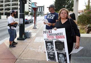 Alma Chavez pickets in front of the Mob Museum before a Police Use of Force panel at the Mob Museum Wednesday, July 25, 2018. Chavez' son Rafael Olivas was shot and killed by police in 2011. Chavez filed a federal civil rights lawsuit against the officers and the Metro Police Department but the case was dismissed by U.S. District Judge.