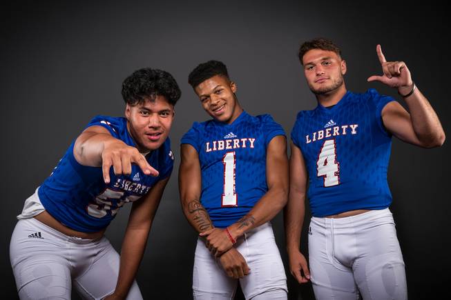 Members of the Liberty High football team pose for a photo at the Las Vegas Sun's high school football media day Tuesday July 31, 2018, at the Red Rock Resort. They include, from left, Troy Fautanu, Cervontes White and Kyle Beaudry.