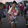 Maria Gomez, 22, carries her son David Moises, 1, as the thousands-strong caravan of Central Americans migrants hoping to reach the U.S. border moves onward from Juchitan, Oaxaca state, Mexico, Thursday, Nov. 1, 2018. Thousands of migrants resumed their slow trek through southern Mexico on Thursday, after attempts to obtain bus transport to Mexico City failed.