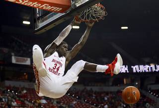 UNLV Rebels forward Cheikh Mbacke Diong (34) hangs on the rim after dunking against Loyola Marymount Lions at the Thomas & Mack Center Saturday, Nov. 10, 2018.