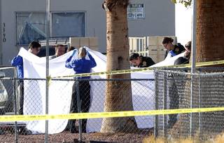 Metro Police and crime scene analysts investigate a fatal shooting in a neighborhood near Desert Inn Road and Cambridge Street Saturday, Nov. 17, 2018.