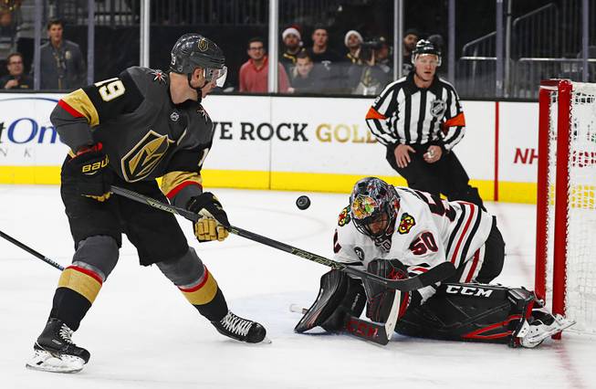 Chicago Blackhawks goaltender Corey Crawford (50) blocks a shot by Vegas Golden Knights right wing Reilly Smith (19) during the second period of an NHL hockey game Thursday, Dec. 6, 2018, in Las Vegas.