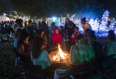 People keep warm around fire pits and roast marshmallows during the 12th annual Night of Lights at St. Jude’s Ranch for Children in Boulder City Saturday, Dec. 8, 2018.