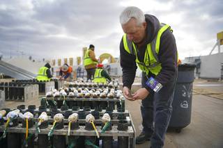 Greg Bottomley from Fireworks by Grucci prepares mortars during fireworks setup on the roof of Planet Hollywood in preparations for New Year's Eve's 