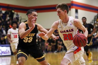 Gorman’s Noah Taitz (20) drives to the basket around Clark defender Vinni Veikalas (33) during a game at Bishop Gorman high school, Monday, Jan. 14, 2019.
