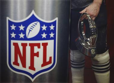 Patriots quarterback Tom Brady holds the championship trophy after the AFC title game against the Chiefs, Sunday, Jan. 20, 2019, in Kansas City, Mo.