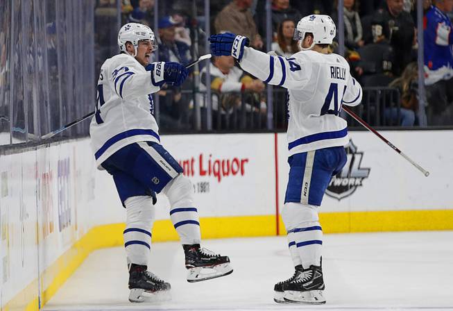 Toronto Maple Leafs center Auston Matthews, left, celebrates after scoring against the Vegas Golden Knights during the second period of an NHL hockey game Thursday, Feb. 14, 2019, in Las Vegas.