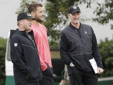 Nick Bosa, center, talks with Oakland Raiders coach Jon Gruden, left, and general manager Mike Mayock during an NFL local pro day April 11 at the team’s football facility in Alameda, Calif.